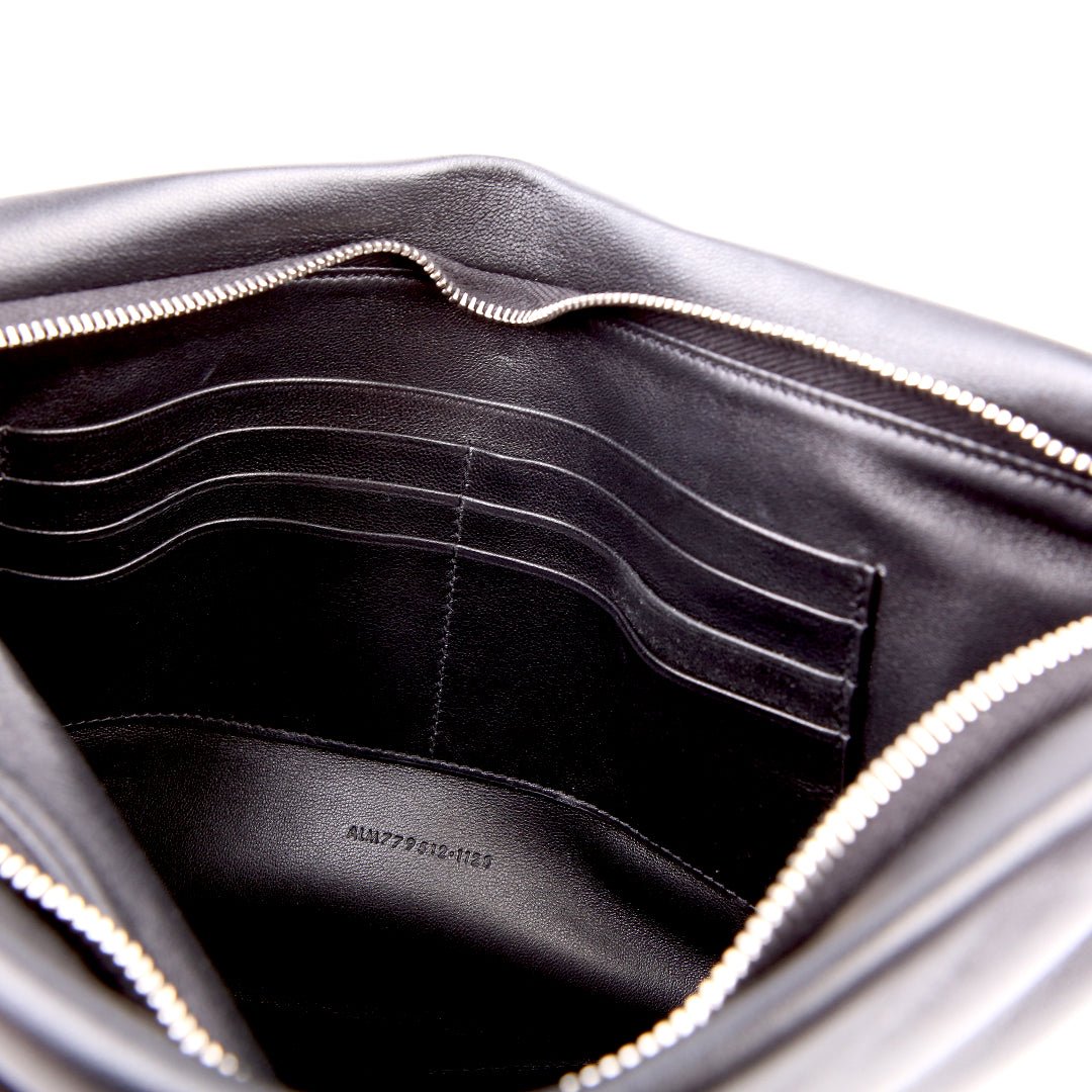 Saint Laurent Large Puffy Pouch in black lambskin, close-up grained texture