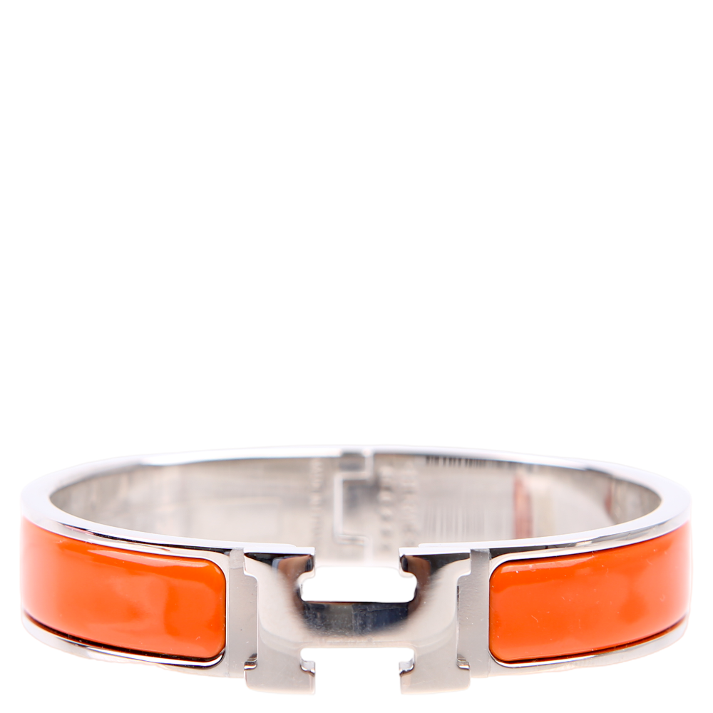 1787318026305PTQ1M1L4A9G5WWAW80CV.png Pre-Owned Hermes Clic Clac Narrow PM Bracelet Silver/Orange | Orange and Silver - Image 1
